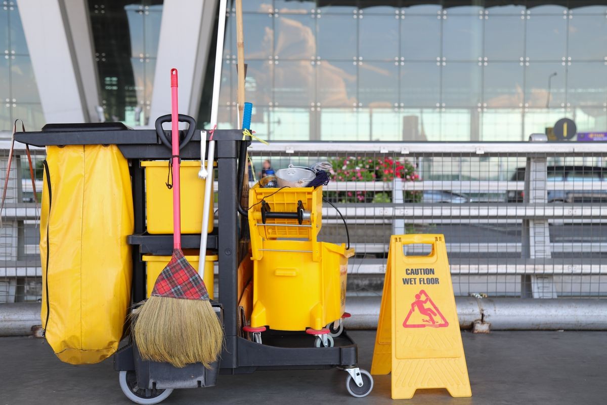 Closeup of cleaning equipments and tools for floor cleaning at the airport with outside terminal background.